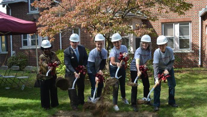 President Mary-Beth Cooper leads a groundbreaking ceremony for the new community center